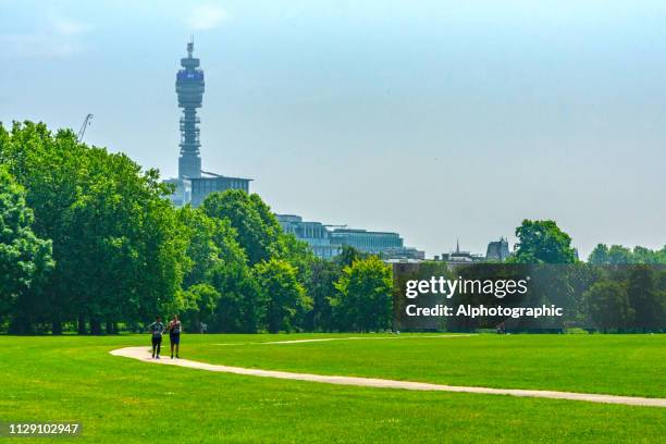 jogger im park in london - bt tower stock-fotos und bilder