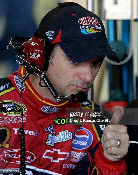 Driver Jeff Gordon sits in the garage during practice for the NASCAR Sprint Cup Camping World RV 400 at the Kansas Speedway in Kansas City, Missouri,...