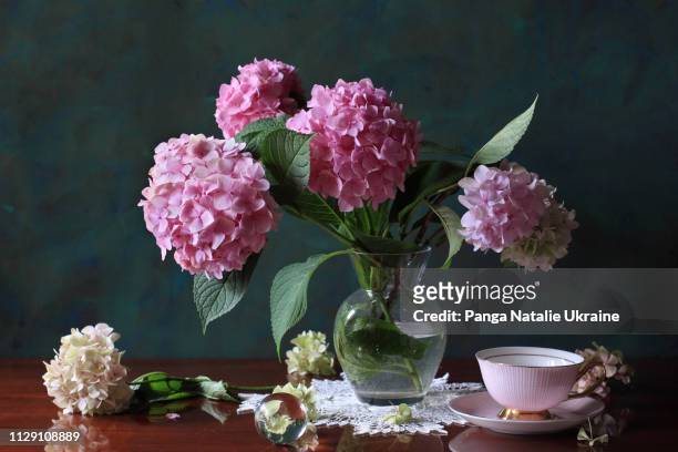 pink hortensia bouquet with porcelain cup and crystal sphere - アジサイ ストックフォトと画像