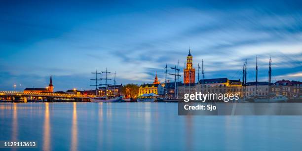 nighttime view on the city of kampen at the river ijssel in the netherlands. - kampen overijssel stock pictures, royalty-free photos & images