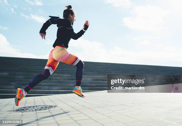 sportswoman sprinting in the city - sprint stock pictures, royalty-free photos & images