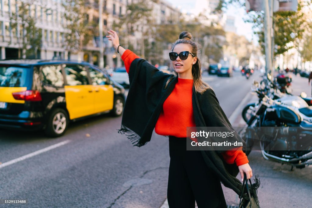 Tourist woman hailing a taxi in Barcelona