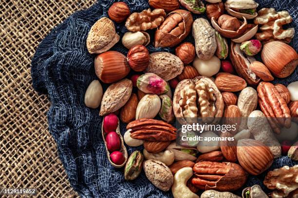 close-up of a variety of dried fruit and nuts on a table - sunflower seed stock pictures, royalty-free photos & images