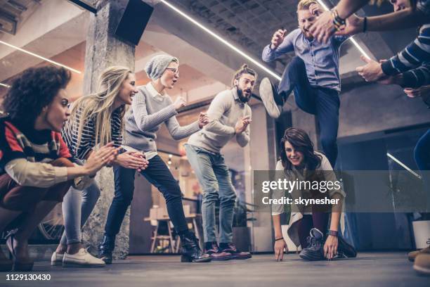 playful freelancers having fun on a break at casual office. - escapism stock pictures, royalty-free photos & images