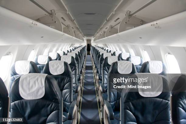empty airplane - aisle seat airline stock-fotos und bilder