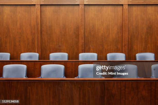 empty chairs in jury box - gericht stock-fotos und bilder