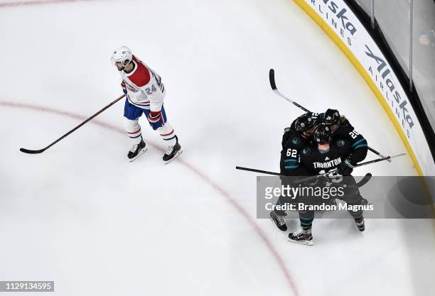 An overhead view as Kevin Labanc, Joe Thornton and Marcus Sorensen of the San Jose Sharks celebrate scoring a goal against the Montreal Canadiens at...
