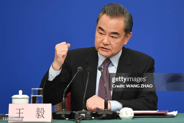 China's Foreign Minister Wang Yi reacts as he answers a question during a National People's Congress press conference in Beijing on March 8, 2019. -...