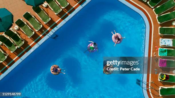 family in swimming pool on holiday - family holidays hotel stock pictures, royalty-free photos & images