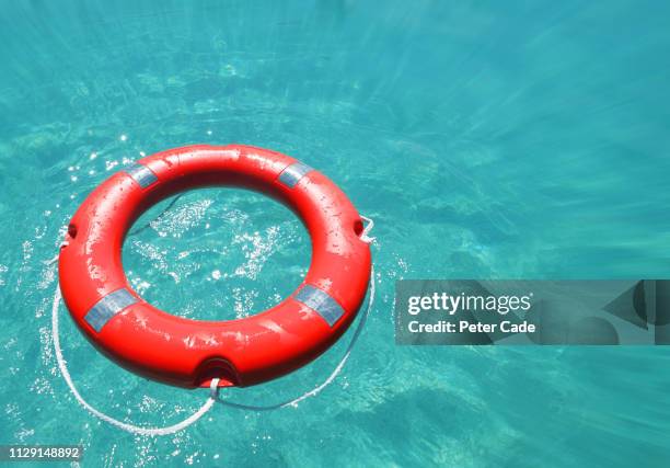 life rings in water - drowning stock-fotos und bilder