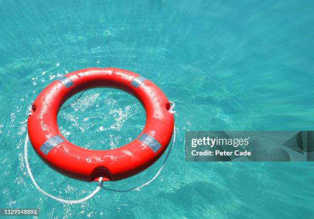 life rings in water - drowning foto e immagini stock