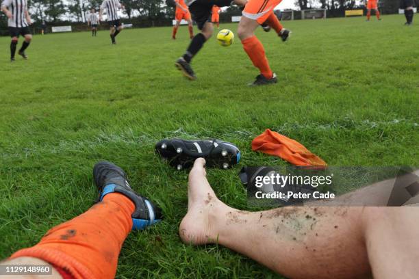 man with injured ankle at football game - injured football player stock pictures, royalty-free photos & images