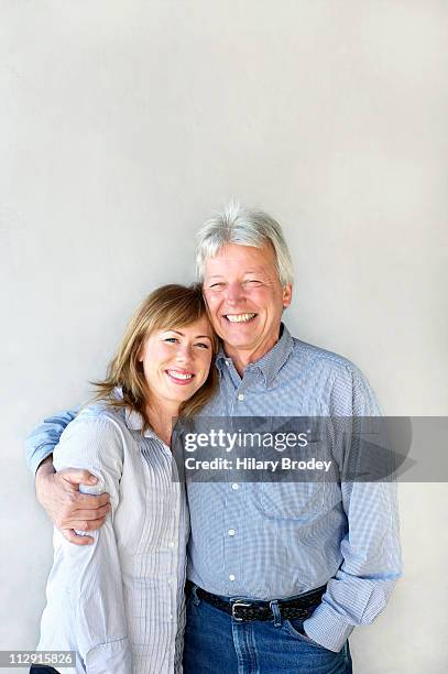 happy couple - couples studio portrait stock-fotos und bilder