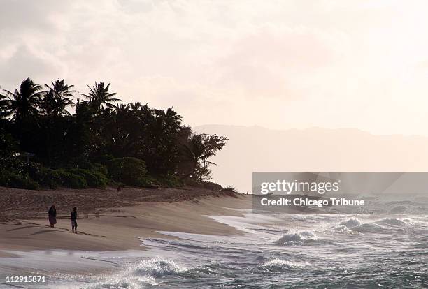 On Hawaii's Oahu North Shore, the surfing magnet of Sunset Beach is almost deserted in the late afternoon.