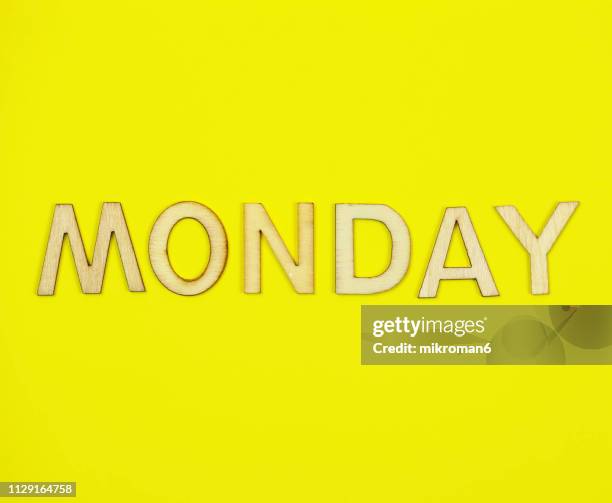 shot of yellow paper background with word monday - monday fotografías e imágenes de stock