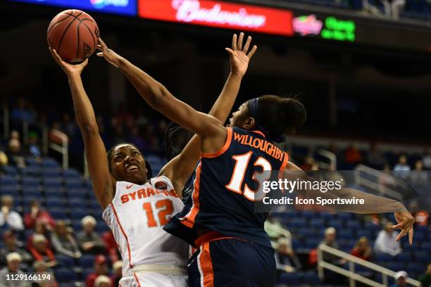 Syracuse Orange guard Kiara Lewis shoots against Virginia Cavaliers guard Jocelyn Willoughby during the ACC Women's basketball tournament between the...