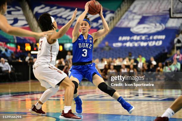 Duke Blue Devils guard Miela Goodchild cuts around Florida State Seminoles guard Nausia Woolfolk during the ACC Women's basketball tournament between...