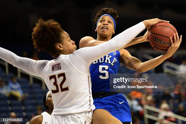 Duke Blue Devils forward Leaonna Odom is blocked by Florida State Seminoles forward Valencia Myers during the ACC Women's basketball tournament...