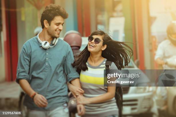 happy young couple on city road. - positiv stock pictures, royalty-free photos & images