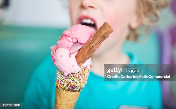 kid with an ice cream - child eating a fruit stock-fotos und bilder