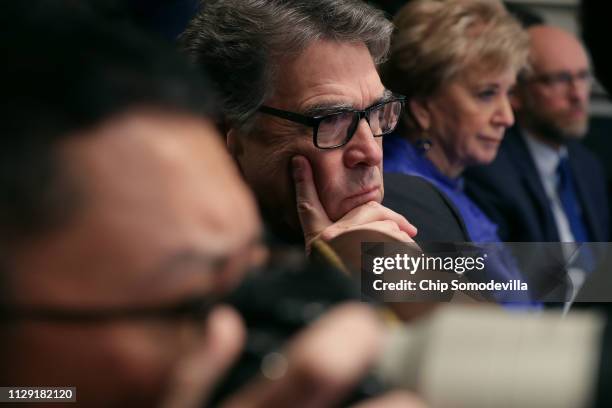 Energy Secretary Rick Perry listens to U.S. President Donald Trump talk to reporters during a cabinet meeting in the Cabinet Room at the White House...