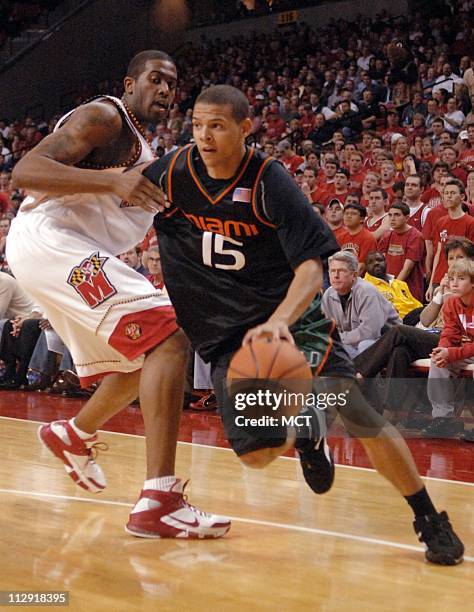 Miami's Denis Clemente drives by Maryland's Travis Garrison in the first half of the Hurricanes' game against the Terrapins at the Comcast Center in...