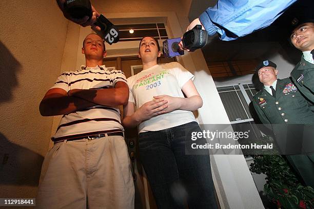 As two U.S. Army officers look on, the children of freed American hostage Keith Stansell, Kyle and Lauren, speak briefly to the media gathered at...