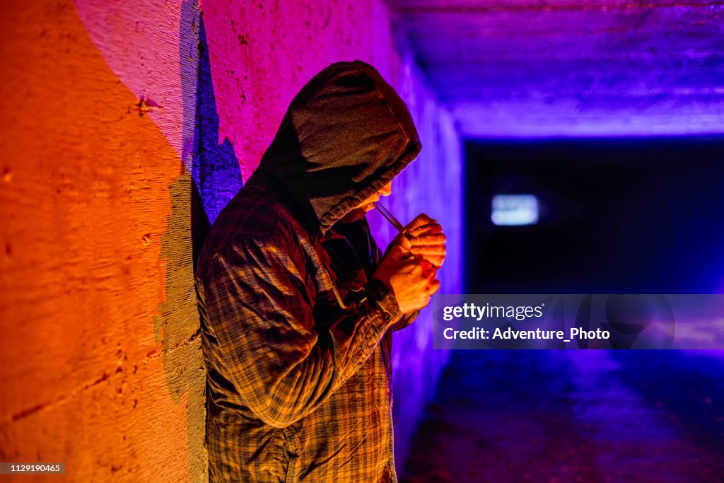 Criminal Drug Addict Smoking Drugs in Underground Tunnel