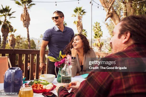 family enjoying backyard dinner party - los angeles garden party stock pictures, royalty-free photos & images