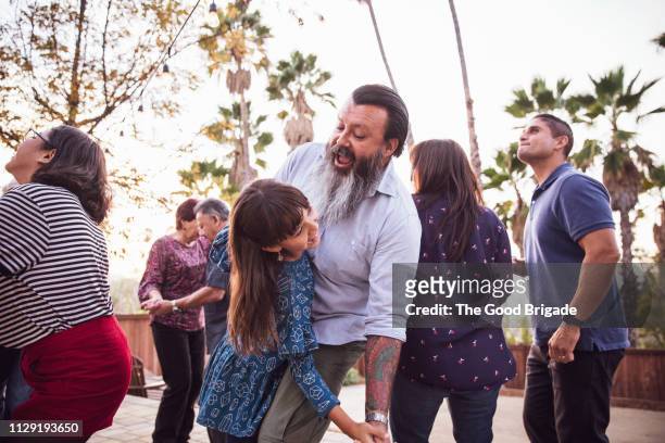 father and daughter dancing together at family party - la neighborhood stockfoto's en -beelden