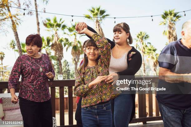 cousins dancing at backyard family party - los angeles garden party stock pictures, royalty-free photos & images