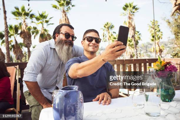 Adult men taking selfie in backyard
