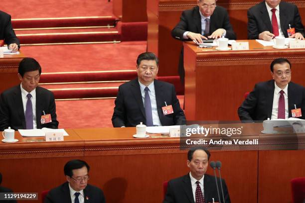 Chinese President Xi Jinping , Chinese Premier Li Keqiang and Chairman of the Standing Committee of the National People's Congress Li Zhanshu listen...