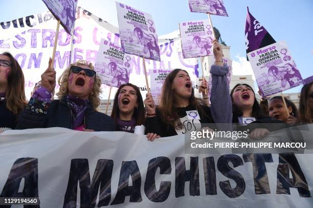 Protesters shout slogans while holding signs reading "General student strike against macho violence, patriarchal and Francoist justice, and...