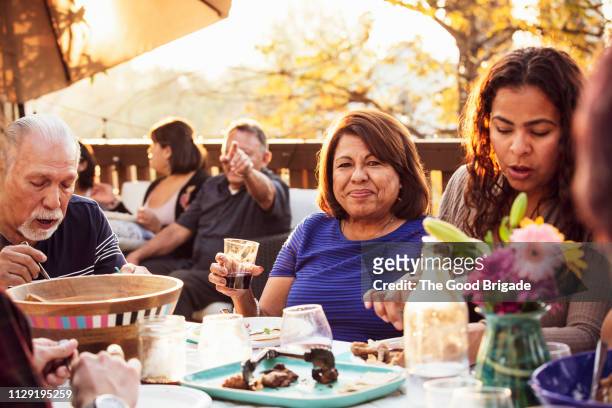 Multi-generation family enjoying outdoor dinner party