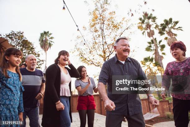 family watching grandparents dance at party - los angeles garden party stock pictures, royalty-free photos & images