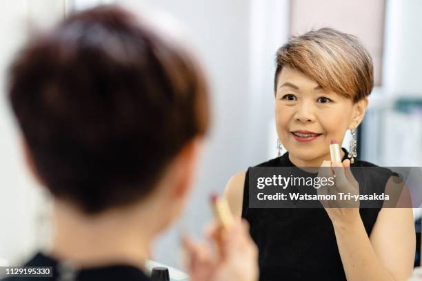 thai middle-aged woman gets ready before work - showus makeup stock pictures, royalty-free photos & images