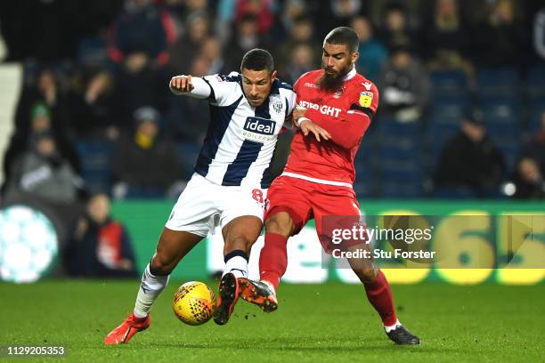 Jake Livermore of West Brom and Lewis Grabban of Nottingham Forest battle for the ball during the Sky Bet Championship match between West Bromwich...