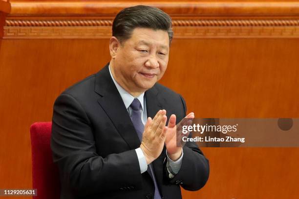 Chinese President Xi Jinping attend the second plenary meeting of the second session of the 13th National People's Congress at the Great Hall of the...