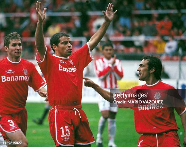 Carlos Maria Morales of Toluca, celebrates with teammates Vicente Sanchez and Maximiliano Cuberas their goal against Necaxa, in Toluca, Mexico 12...