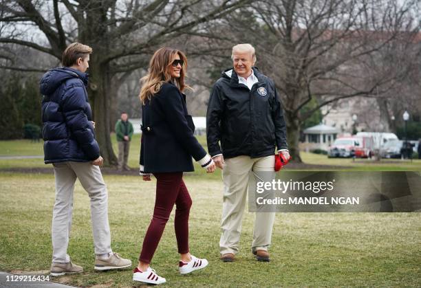 President Donald Trump is joined by First Lady Melania Trump and their son Barron before boarding Marine One to depart from the South Lawn of the...