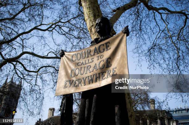 People stop and take pictures to the Statue of Millicent Garrett Fawcett is pictured in Parliament Square, London on March 8, 2019. Dame Millicent...