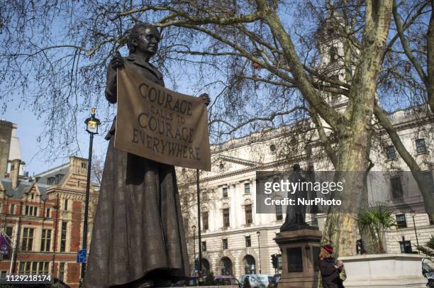 People stop and take pictures to the Statue of Millicent Garrett Fawcett is pictured in Parliament Square, London on March 8, 2019. Dame Millicent...