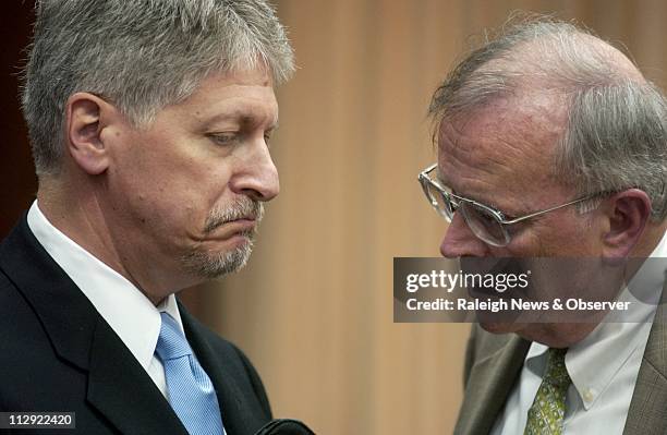 Former Durham District Attorney Mike Nifong speaks with his attorney Jim Glover in the Durham County Courthouse in Durham, North Carolina on...