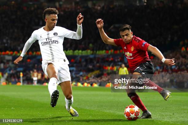 Alexis Sanchez of Manchester United takes on Thilo Kehrer of PSG during the UEFA Champions League Round of 16 First Leg match between Manchester...