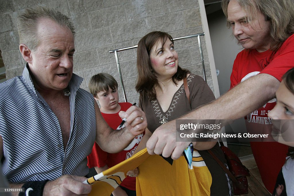 Deborah Gray, 41, of Apex, center, gets a shirt signed by Ja