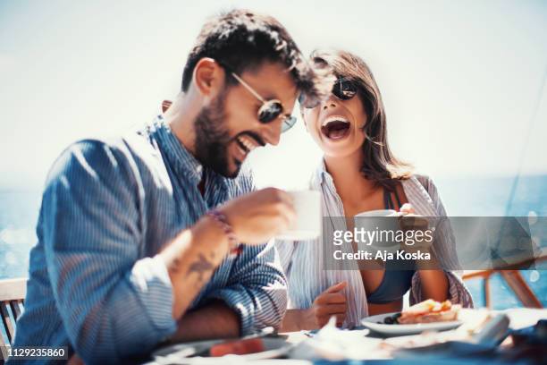 coffee and fun on the sailing. - couple on beach stock pictures, royalty-free photos & images