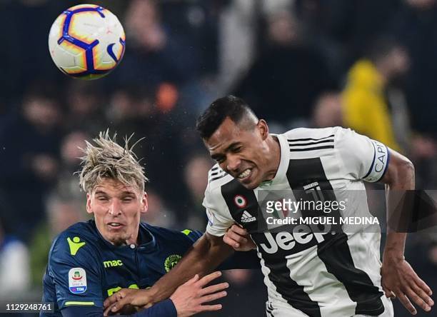 Udinese's Danish defender Jens Stryger Larsen and Juventus' Brazilian defender Alex Sandro go for a header during the Italian Serie A football match...