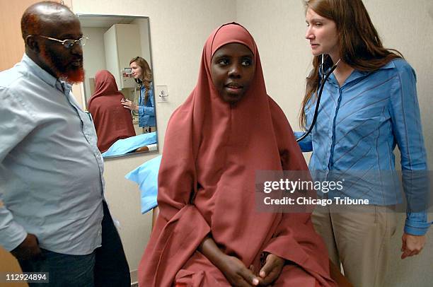 Osman Musse, liaison and interpreter to the Somali community, translates for Sabah Omar, who is undergoing a prenatal examination with doctor...