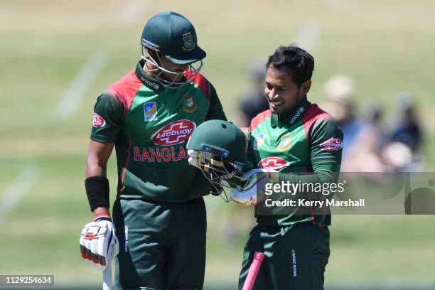 Mohammad Mushfiqur Rahim of Bangladesh checks his helmet after being hit by a bouncer during Game 1 of the One Day International series between New...